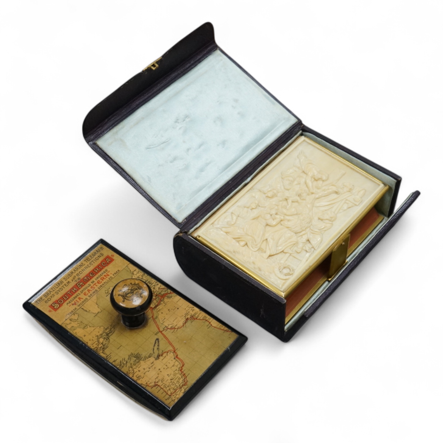 A leather boxed Common Prayer book with relief Crucifixion scene and advertising ink blotter, The Brazilian Submarine Telegraph 13cm high